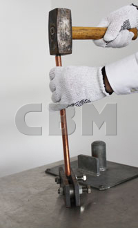 Copper-bonded rod driven with a hammer between the steel plates of a test tool